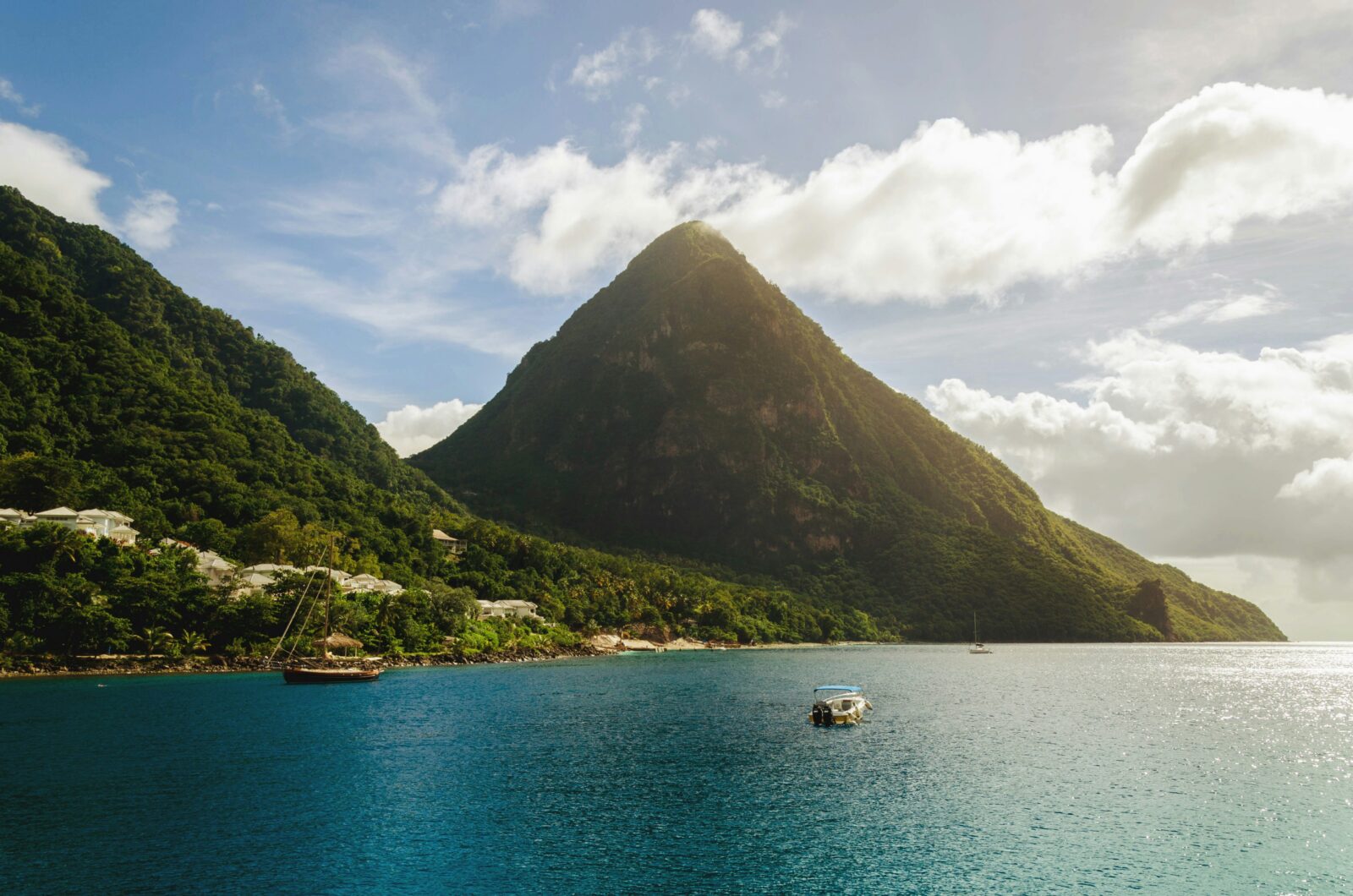 The Pitons volcanic peaks rising above the Caribbean sea in St. Lucia — one of the best places to live in the Caribbean for American families
