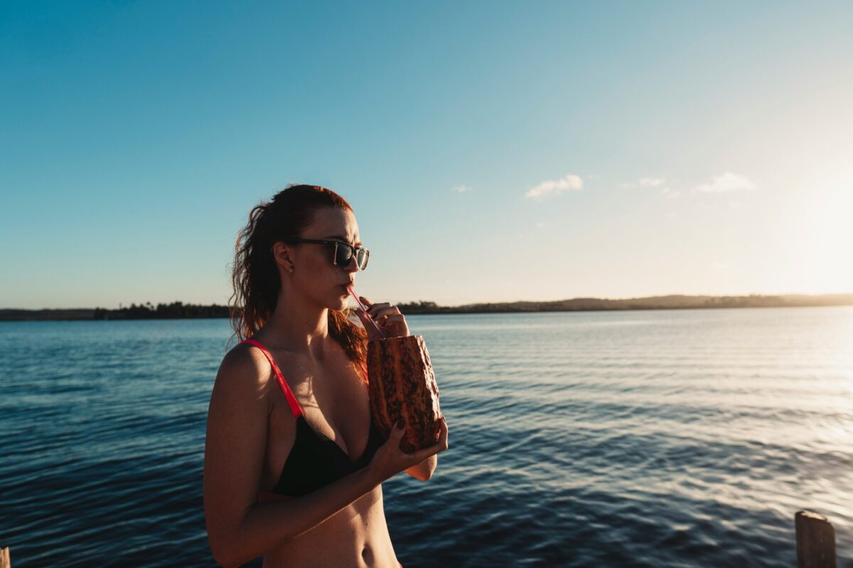 A woman enjoying the sunset over the ocean in Morro de São Paulo, Brazil