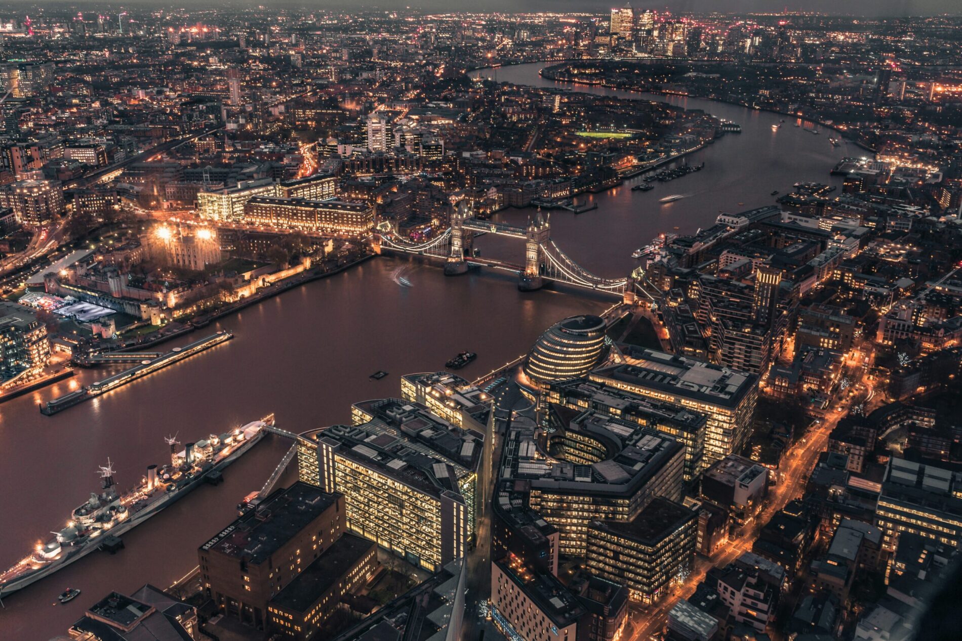 Aerial night view of London and the Thames, the city that anchors any cost of living UK vs USA comparison