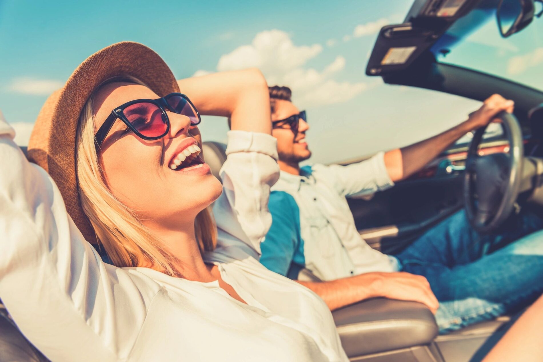 Woman enjoying convertible car drive - American vehicle UK import lifestyle