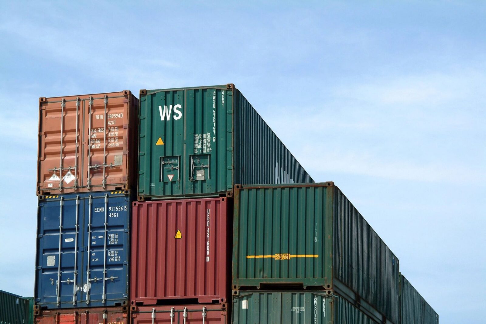 Stacked shipping containers representing groupage freight costs in international removals